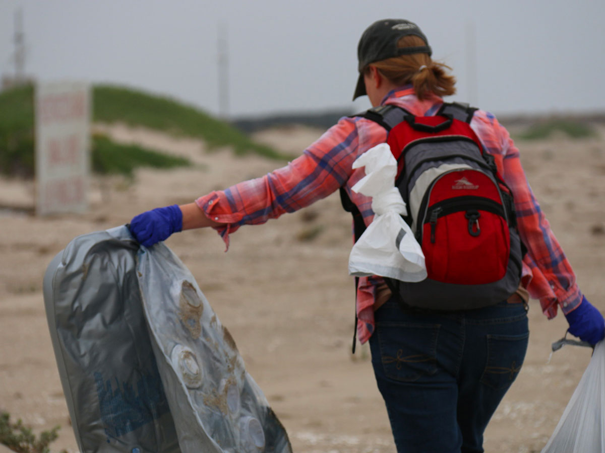 FWS biologist Jenny Marek doing beach cleanup.